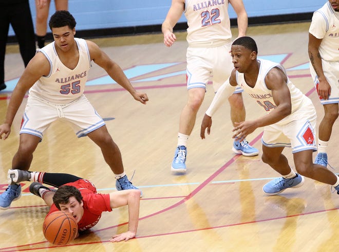 Alliance's Nick Oldfield (55) and Jeff Talbert, right, and Canton's South's Luke Battery go for a loose ball during action at Alliance High School on Friday. Ed Hall Jr, Special to The Review
