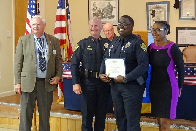 Officer Travonte Kitchen, holding certificate, is flanked by, from left, Lake-Sumter Chapter President Allan Lane, Leesburg Capt. Joe Iozzi, and friend Ava Martin. [SUBMITTED]