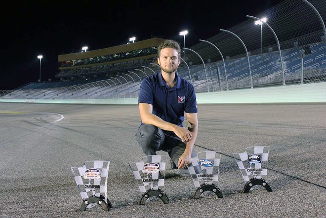 This Nov. 18, 2018, photo provided by Bryan Blackford and Snowcone Productions shows Ray Alfalla with his awards on the track at Homestead-Miami Speedway in Homestead, Fla. Alfalla is in the elite class of drivers who have mastered virtual iRacing, an online simulation of the real deal each week in NASCAR. [BRYAN BLACKFORD/SNOWCONE PRODUCTIONS/ASSOCIATED PRESS]