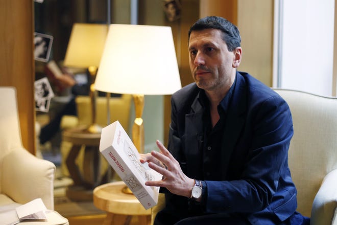 French writer Frederic Martel gestures during an interview with Associated Press, in Paris, Friday, Feb. 15, 2019. In the explosive book "In the Closet of the Vatican" author Frederic Martel describes a gay subculture at the Vatican and calls out the hypocrisy of Catholic bishops and cardinals who in public denounce homosexuality but in private lead double lives. [AP Photo/Thibault Camus]
