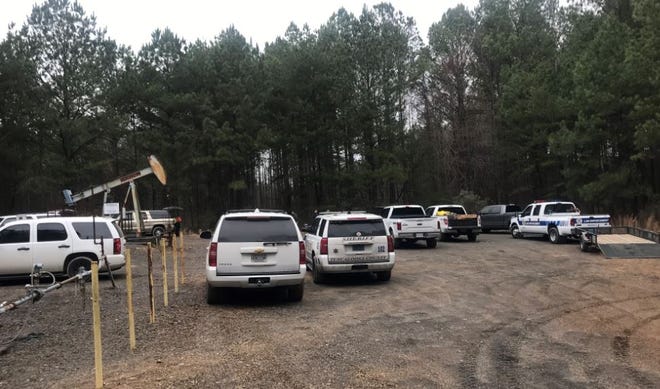 Investigators have been searching the area off Warrior Cemetery Road where a skull was found, using metal detectors and tracking dogs. [Staff photo/Stephanie Taylor]