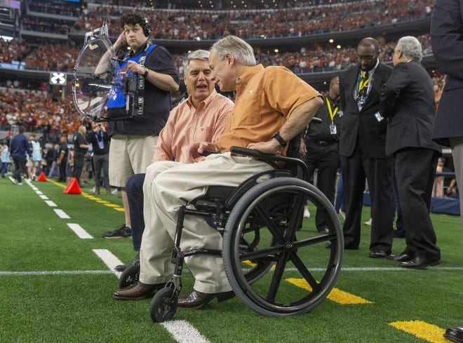 University of Texas President Gregory L. Fenves joins Gov. Greg Abbott, right, at the Big 12 Conference football championship in December. Speaking to legislators last week, Fenves voiced his support for the governor's University Research Initiative, a fund for recruiting high-profile scientists, engineers and physicians to public universities. Abbott has requested $40 million plus the fund's unexpended balance of $26.2 million for the next two years, but the initial House and Senate bills allocate only the unexpended balance. [STEPHEN SPILLMAN/FOR STATESMAN]