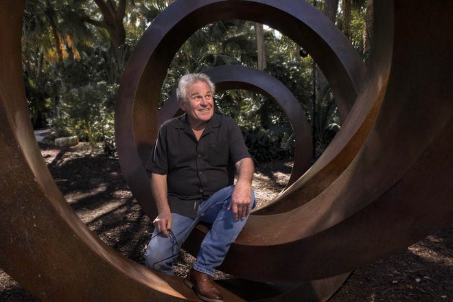 Gino Miles considers his monumental bronze sculpture 'Shelter' his masterpiece. The piece is part of 'Contours in Metal: Sculptures by Gino Miles,' on view at the Ann Norton Sculpture Gardens in West Palm Beach. [Damon Higgins/palmbeachdailynews.com]