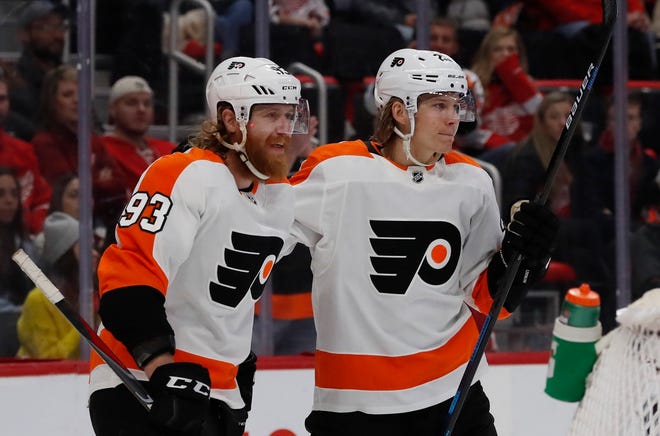 Philadelphia Flyers right wing Jakub Voracek, left, congratulates teammate left wing Oskar Lindblom after a goal during the first period Sunday. [Carlos Osorio / The Associated Press]