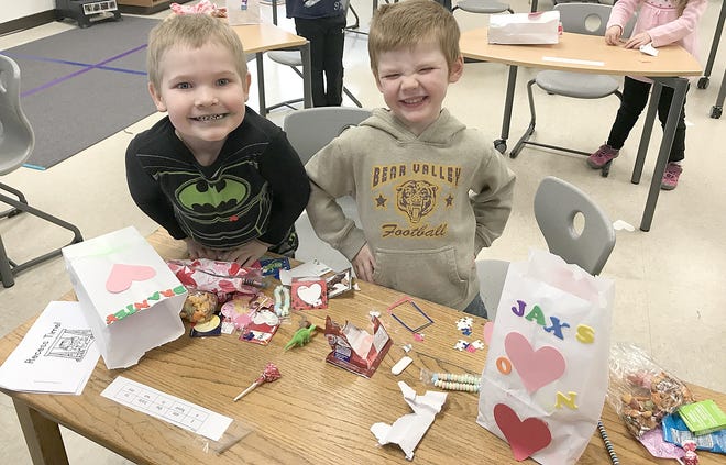 Brantley Peck and Jaxson Heyob pose for a picture as they look through their decorated Valentine’s Day bags.