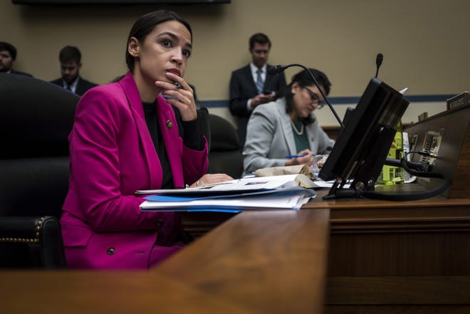 Rep. Alexandria Ocasio-Cortez, D-N.Y., listens to testimony during a hearing by the House Oversight and Government Reform Committee. Ocasio-Cortez is an architect of the “Green New Deal.” [J. Lawler Duggan/The Washington Post]