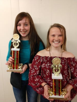 Linde Haun, left, won the trophy for best entry in the Loudonville Junior High Science Fair on Wednesday, Feb. 13, while Emma Burkhalter was runner-up.
