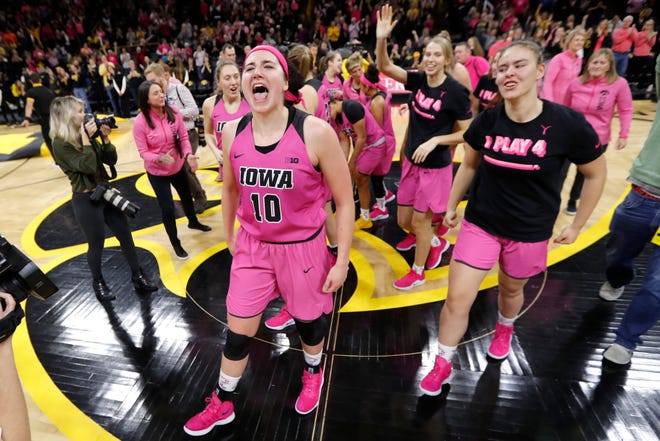 Iowa forward Megan Gustafson (10) celebrates with her teammates after Sunday's 86-73 win over Maryland. [Charlie Neibergall/The Associated Press]