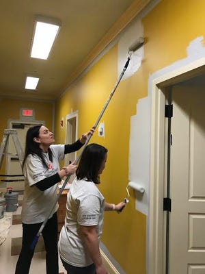 Carrie LeBlanc and Michelle Helfrich paint the walls inside the Respite Center.