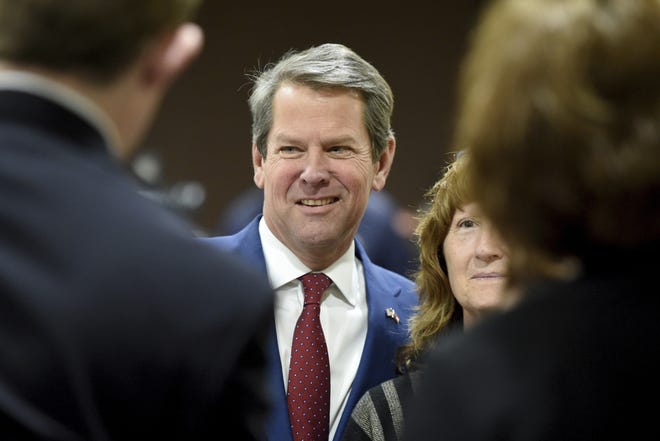 Georgia Governor-elect Brian Kemp, middle, poses for photos with supporters during a stop in Augusta, Ga., last month. (Michael Holahan/The Augusta Chronicle via AP)