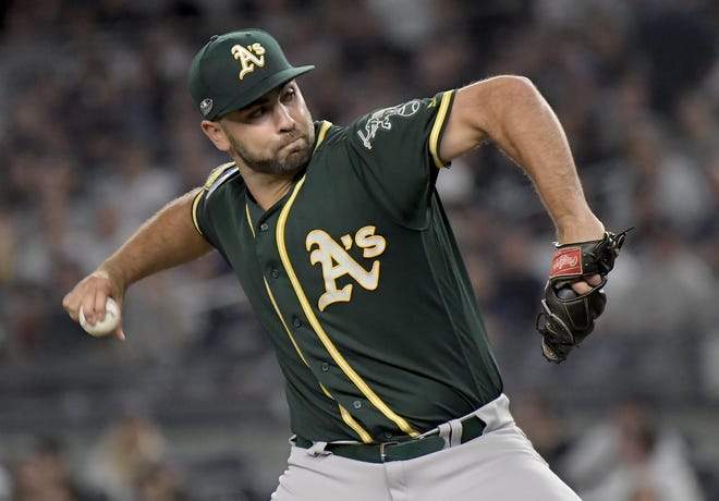 Athletics reliever Lou Trivino, a former standout for the Quakertown Blazers and Pennridge Legion, delivers during the second of his three shutout innings in a 2018 wild-card playoff game at Yankee Stadium. [ASSOCIATED PRESS]