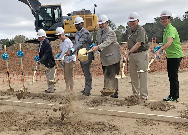 Mount Dora Councilman Harmon Massey, Councilwoman Laurie Tillet, AdventHealth Waterman President Abel Biri, Mount Dora Mayor Nick Girone, Councilman Cal Rolfson and Councilwoman Crissie Stile turn dirt at the groundbreaking ceremony for AdventHealth's future medical plaza near Wolf Branch Road and the city's business innovation district.  [Roxanne Brown/Daily Commercial]