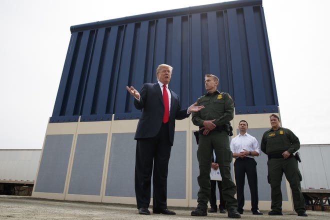 President Donald Trump talks with reporters as he reviews border wall prototypes in San Diego. California's attorney general filed a lawsuit Monday, against Trump's emergency declaration to fund a wall on the U.S.-Mexico border. Xavier Becerra released a statement Monday saying 16 states allege the Trump administration's action violates the Constitution. [Evan Vucci/AP Photo]