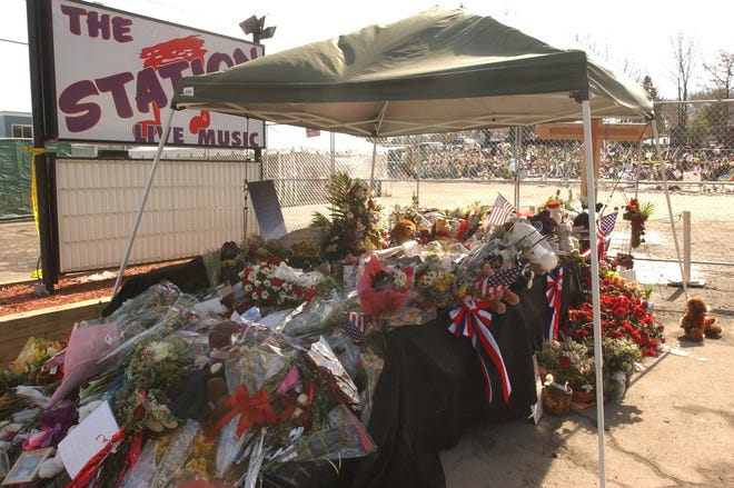 Mourners left flowers and mementos for the fallen victims of the fire near The Station nighclub sign. [PROVIDENCE JOURNAL FILE PHOTO]