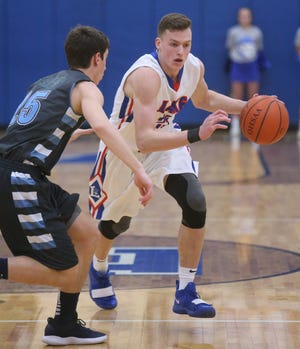 Lake's Jake Maranville drives against Louisville's Cam King during Tuesday night's game at Lake. (CantonRep.com / Scott Heckel)