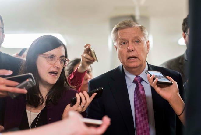 Sen. Lindsey Graham, R-S.C., speaks to journalists while walking to the Senate floor in January. MUST CREDIT: Washington Post photo by Melina Mara.