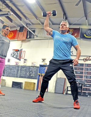 Dr. Michael Knapic does physical therapy at Declaration Crossfit in Wooster with Sam Stine. (GateHouse Media Ohio / Mike Schenk, The Daily Record)