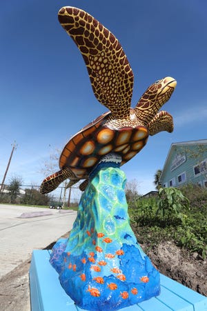 A sea turtle statue is displayed in front of the Campeche Cove Animal and Bird Hospital in Galveston. The Turtle Island Restoration Network is installing statues to promote awareness for sea turtle restoration. [Kelsey Walling/The Galveston County Daily News]