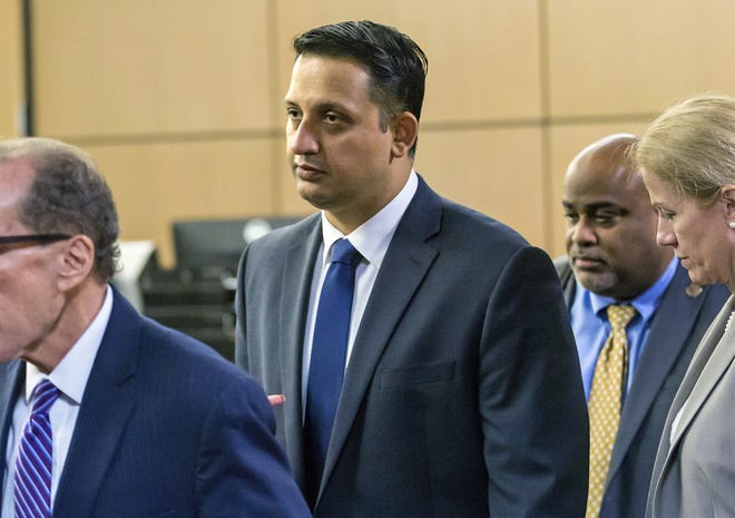 Nouman Raja leaves the courtroom with his legal team after a pre-trial hearing in West Palm Beach. The fired Palm Beach Gardens police officer's trial begins with jury selection today. He is charged with manslaughter for the 2015 shooting of Corey Jones, a 31-year-old black musician. [Lanes Waters/AP Photo]