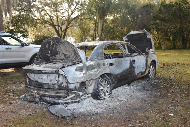 Two cars were set on fire, one of which remains in the yard of the Lake County deputy's home near Umatilla. [Lake County Sheriff's Office]