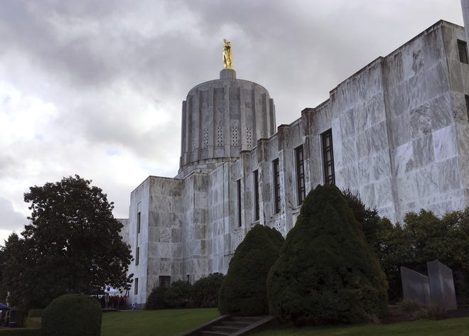 FILE - The Oregon House Health Committee is considering a series of bills designed to lower the cost of prescription drugs in Oregon. This Jan. 11, 2018, file photo shows dark clouds hovering over the Capitol in Salem, Ore. (AP Photo/Andrew Selsky, File)