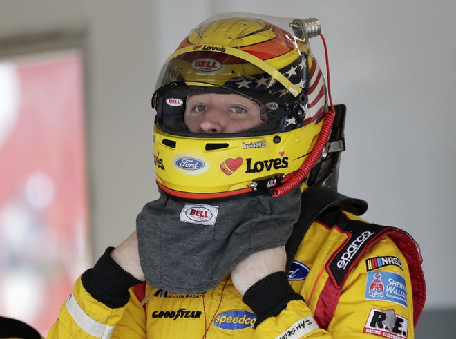 Michael McDowell adjusts his helmet before a practice session Friday for the Daytona 500 auto race last Sunday at Daytona International Speedway in Daytona Beach, Fla. [JOHN RAOUX/THE ASSOCIATED PRESS]