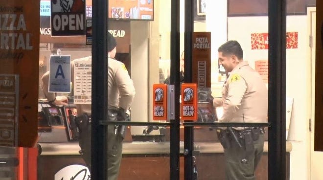 San Bernardino County Sheriff's Department officials investigate an armed robbery at a local Little Caesars restaurant in Hesperia Wednesday. [Submitted photo]