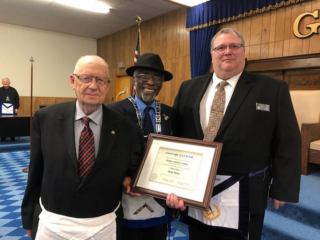 Gerald Carter, left, is presented a certificate by Lincoln Masonic Lodge #210 Worshipful Master Dwight Reed, center and District Deputy Grand Master Christopher Whitney, right, during a recent meeting at the lodge. [Photo submitted]