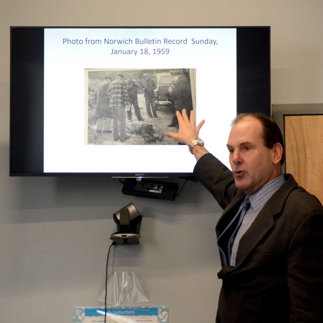 Sam Browning presents his finding of what happened in the deaths of Ellis Ruley and his son-in-law, Douglas Harrison. Above, Browning shows a January 18, 1959 Norwich Bulletin photo clipping covering Ruley’s death. [Aaron Flaum/NorwichBulletin.com]