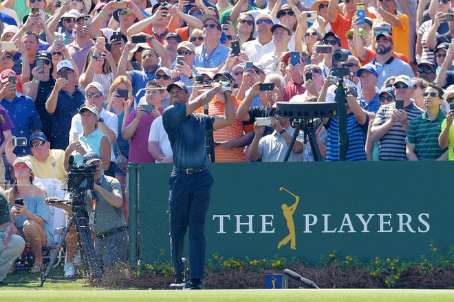 Tiger Woods tees off the 17th hole of the Stadium Course at TPC Sawgrass during the 2018 Players Championship. He announced he would return to the event next month for his 18th career start. [Bob Self/Florida Times-Union]