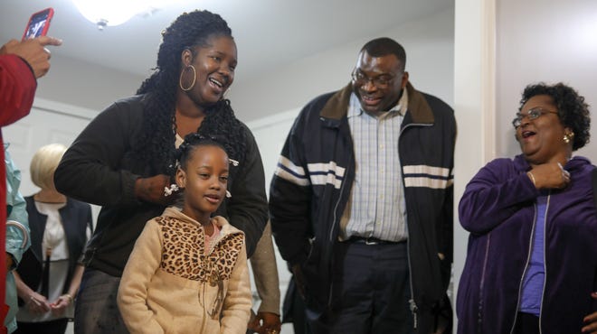 Tiffany Lawrence, William McDowell and Mattie Moffit react to Larence's daughter, Cordasia Lawrence, as she speaks about how she feels about her new home. Habitat for Humanity dedicated the house on Seventh Street to the Lawrence family on Wednesday, Feb. 20, 2019. [Photo/Joe Will Field]