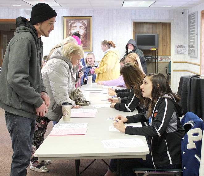 Pittsford High School NHS students help register during Project Connect at the Hillsdale Free Methodist Church Thursday. [NANCY HASTINGS/Hillsdale Daily News Photo]