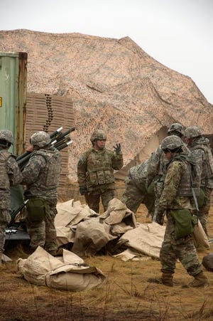 Staff Sgt. Silvel Hammel, center, commands the Soldiers of The 77th Sust. Bde. in the breakdown and organization of camp at the Warfighter exercise at Fort Bragg. The 77th had been living in the field for two weeks during the exercise.