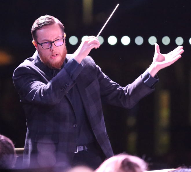 Matthew Wardell conducts the Ocala Symphony Orchestra and the Ocala Youth Symphony during last year's Symphony Under the Lights at the Reilly Arts Center's outdoor stage. Wardell marks his 10th year as OSO's conductor in 2019. [Bruce Ackerman/Ocala Star-Banner]
