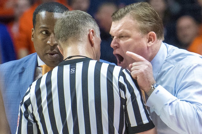 Illinois head coach Brad Underwood gives a piece of his mind to a referee as asstitant coach Ron Coleman listens during the second half of Saturday's game against Penn State in Champaign. [AP Photo/Robin Scholz]