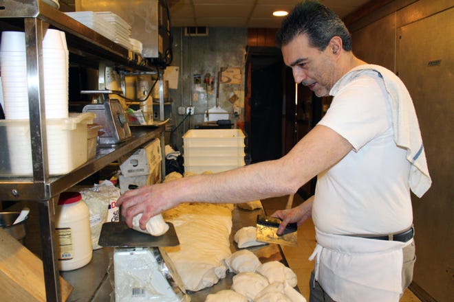 Carlo Prespitino prepares the dough at Tony's Restaurant & Pizzeria in East Stroudsburg. Tony's plans on expanding with a new location in Tannersville next month. [BRIAN MYSZKOWSKI/POCONO RECORD]