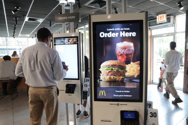 McDonald's is rolling out ordering kiosks in many of its restaurants across the country. The company has also created the role of "guest experience leader" to help customers navigate the kiosks. (Antonio Perez/Chicago Tribune/TNS)