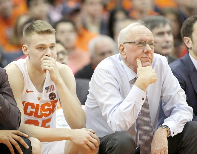 Syracuse coach Jim Boeheim (right) and his son Buddy Boeheim (left) sit on the bench in the final minutes of the team’s Saturday game against Duke at the Carrier Dome. Duke won 75-65.         

[Nick Lisi / Associated Press]