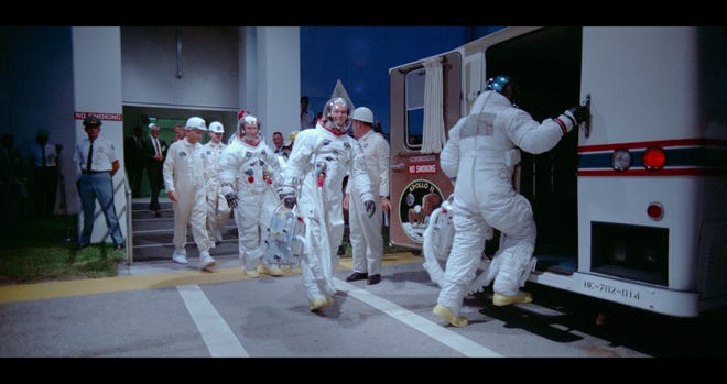 Neil Armstrong, Buzz Aldrin, and Michael Collins board the shuttle that will take them to Launch Pad A. [Neon]