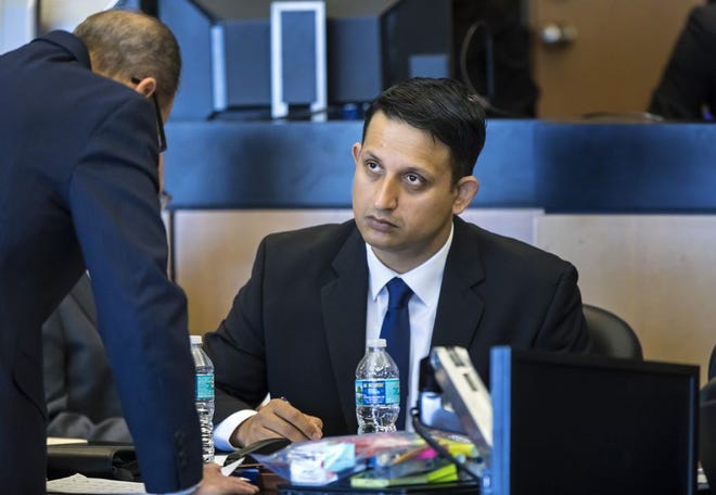 Nouman Raja talks with defense attorney Richard Lubin during a break in jury selection Thursday, February 21, 2019. Raja, a former Palm Beach Gardens police officer, is charged with shooting and killing stranded motorist Corey Jones Oct. 18, 2015, while Raja worked as an undercover officer. He is charged with manslaughter by culpable negligence while armed and attempted first-degree murder with a firearm. [LANNIS WATERS/palmbeachpost.com] POOL