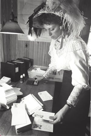 Virginia Couch, a Clerk with the Palmetto Post Office, puts special cancellation stamp on cards at the 1880 Post Office in the Palmetto Historical Park at the start of Heritage Week on March 18, 1990. [Submitted photo]