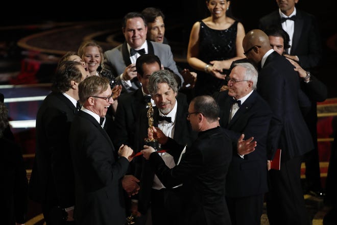 The creative team behind "Green Book," the film that won the best picture Oscar, in Los Angeles on Sunday. While criticized by some as a simplistic take on race relations, "Green Book" was admired by others as a feel-good depiction of people bonding against the odds. [The New York Times / Noel West]