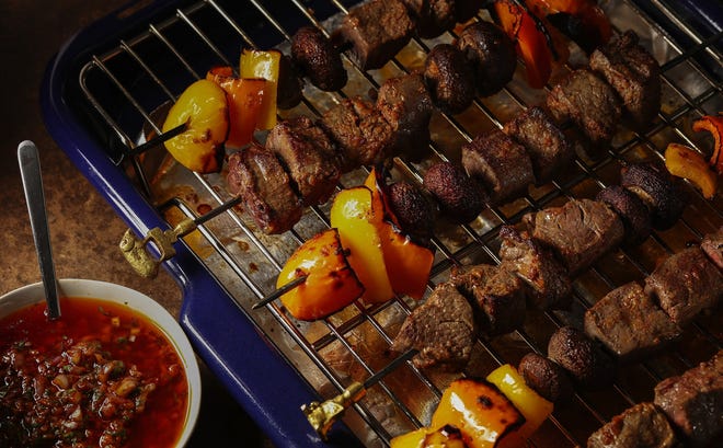 Chunks of beef alternate with bell peppers and baby bella mushrooms for kebabs coated with a spicy red chimichurri sauce. [ABEL URIBE/CHICAGO TRIBUNE/TNS]