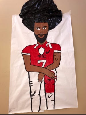 A poster of Colin Kaepernick that was taken down from a Black History Month display at Abby Kelley Foster Charter Public School earlier this month is going back up. [Submitted Photo]