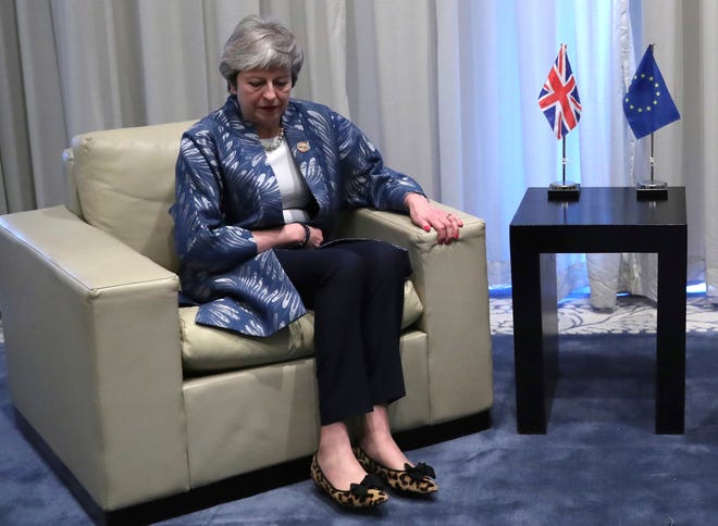 British Prime Minister Theresa May takes her seat as she prepares to meet with European Council President Donald Tusk for a bilateral meeting on the sidelines of a summit in Sharm El Sheikh, Egypt, on Sunday, Feb. 24, 2019. [Francisco Seco/Pool via AP]