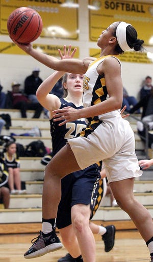 Kings Mountain girls basketball standout Hannah Clark rises for a layup as a T.C. Roberson player looks on during their first round playoff matchup on Tuesday. [JOHN CLARK/THE GASTON GAZETTE]