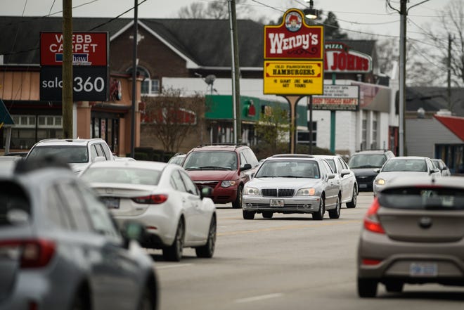 A car waits to make a left turn from Raeford Road onto Ravenhill Drive on Wednesday. The first phase of a long-awaited safety improvement project along Raeford Road is expected to begin in June. The project includes installing medians. [Andrew Craft/The Fayetteville Observer]