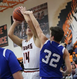 Mitch Neidenthal of Strasburg shoots over Kollin Ludwig of Beallsville in the Division IV sectional game at Strasburg Tuesday. (TimesReporter.com / Jim Cummings)