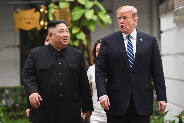 President Donald Trump, right, walks with North Korea’s leader Kim Jong Un during a break in talks at the second U.S.-North Korea summit at the Sofitel Legend Metropole hotel in Hanoi on Feb. 28, 2019. (Saul Loeb / AFP / Getty Images)