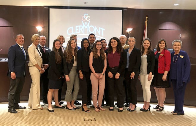 Members of the Clermont Youth Council pose with Clermont City Council members and city administrators after approaching city leaders with an idea for a community of tiny homes for veterans and the homeless Tuesday. [Roxanne Brown/Daily Commercial]